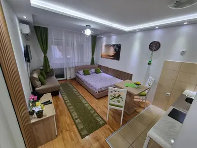a living room with a couch and a table at ZVEZDA LUX in Kruševac