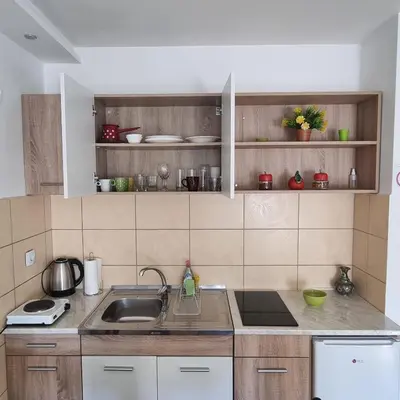 a kitchen with a sink and a counter top at ZVEZDA LUX in Kruševac