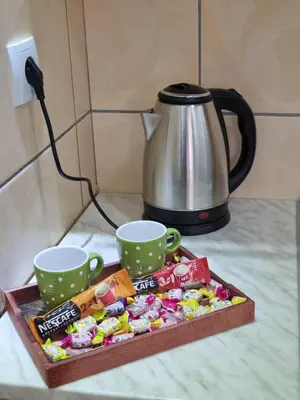 a tray of candy and two cups on a counter at ZVEZDA LUX in Kruševac