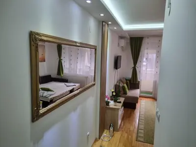 a mirror on the wall of a room with a bed at ZVEZDA LUX in Kruševac