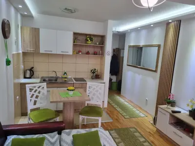 a kitchen and a living room with a table at ZVEZDA LUX in Kruševac