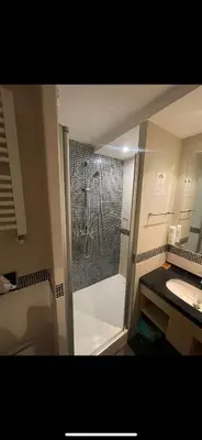 a bathroom with a shower and a toilet and a sink at Apartmani Dušica Konaci Kopaonik in Kopaonik