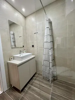 a bathroom with a sink and a shower at Milmari N69 in Kopaonik