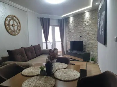 a living room with a couch and a table at Apartman Noalux 2 Kopaonik in Kopaonik