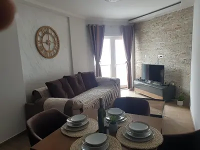 a living room with a couch and a table at Apartman Noalux 2 Kopaonik in Kopaonik
