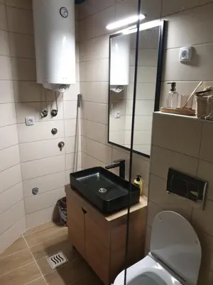 a small bathroom with a toilet and a sink at Apartman Noalux 2 Kopaonik in Kopaonik