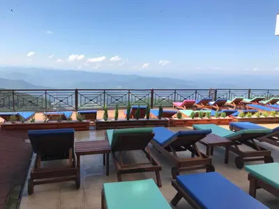 a row of tables and chairs on a roof at Apartman Premier 32 Milmari in Kopaonik