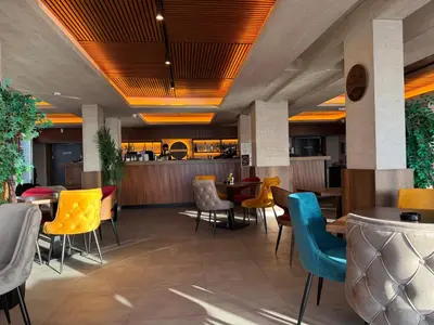a restaurant with tables and chairs and a bar at Apartman Premier 32 Milmari in Kopaonik