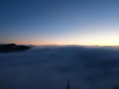 a view of the fog with the sun rising over the horizon at Apartman Horizont Kop in Kopaonik