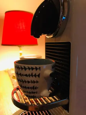 a black and white coffee cup is in a toaster oven at Sunside Oak - 206 in Kopaonik