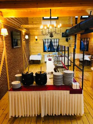 a room with a table with pots and plates on it at Sunside Oak - 206 in Kopaonik