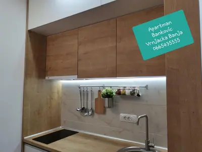 a kitchen with a sink with a sign above it at Bankovic Apartman in Vrnjačka Banja