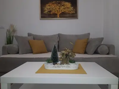 a white coffee table in a living room with a couch at Bankovic Apartman in Vrnjačka Banja