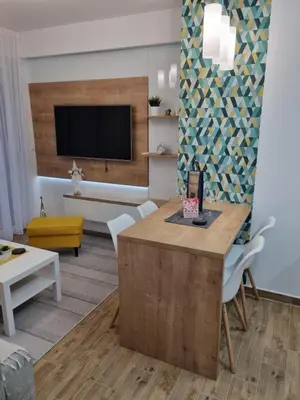 a living room with a table and chairs at Bankovic Apartman in Vrnjačka Banja