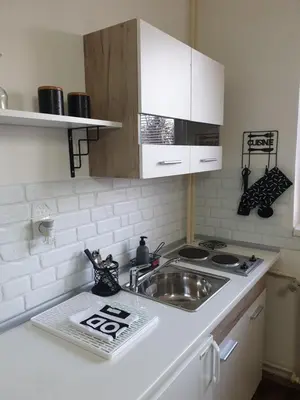 a kitchen counter with a sink and a stove at Apartman Park Jagodina-studio u centru grada FREE parking in Jagodina