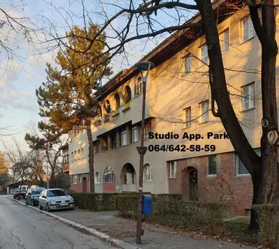 a building with a sign on the side of a street at Apartman Park Jagodina-studio u centru grada FREE parking in Jagodina
