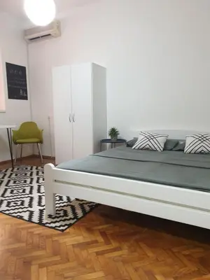 a bedroom with a large bed in a room at Apartman Park Jagodina-studio u centru grada FREE parking in Jagodina