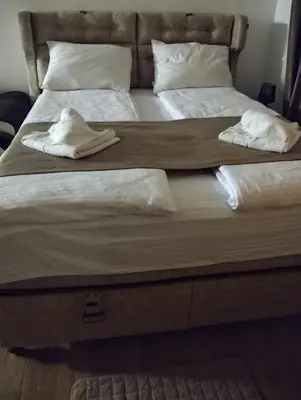 a large bed with two white towels on it at Lela Kop in Kopaonik