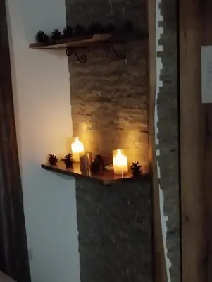 a wall with two candles and lights on it at Lela Kop in Kopaonik