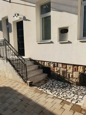 a building with stairs and a door and a window at IN Apartmani in Kruševac