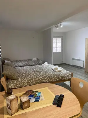 a bedroom with a bed and a wooden table at Vila Nika in Crni Vrh