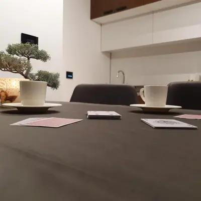 a table with two cups and plates on it at MK Apartments Zoned 2 Spa&Wellness in Cajetina