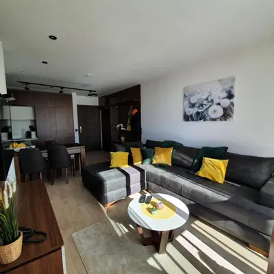 a living room with a couch and a table at MK Apartments Zoned 2 Spa&Wellness in Cajetina