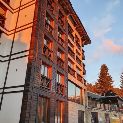 a brick building with windows on the side of it at MK Apartments Zoned 2 Spa&Wellness in Cajetina