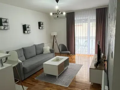 a living room with a couch and a table at Apartman Lux in Vranje