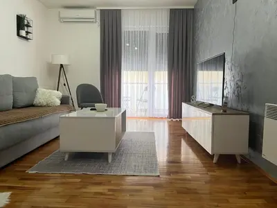 a living room with a couch and a coffee table at Apartman Lux in Vranje