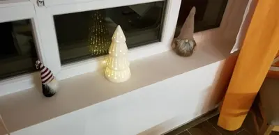 a window sill with christmas decorations on it at Apartman Paunovi Čardaci sa garažnim mestom in Kopaonik