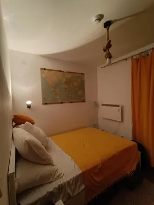 a bedroom with a bed and a map on the wall at Apartman Paunovi Čardaci sa garažnim mestom in Kopaonik