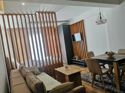 a living room with a couch and a table at President Kop A 407 in Kopaonik