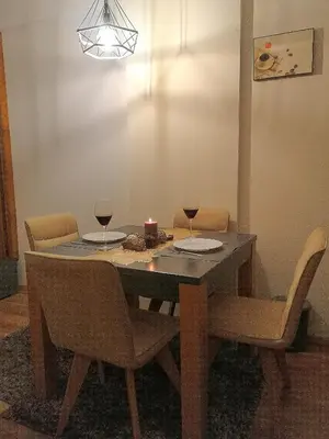 a dining room table with two glasses of wine at President Kop A 407 in Kopaonik