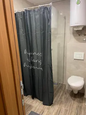 a shower curtain in a bathroom with a toilet at President Kop A 407 in Kopaonik