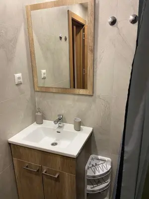 a bathroom with a sink and a mirror at President Kop A 407 in Kopaonik