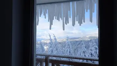 a window with a view of a snowy mountain at SUNČANI BREG RESORT & SPA apartment 14 Kopaonik in Kopaonik
