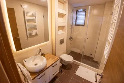 a bathroom with a sink and a toilet and a shower at SUNČANI BREG RESORT & SPA apartment 14 Kopaonik in Kopaonik