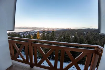 a balcony with a view of the mountains at SUNČANI BREG RESORT & SPA apartment 14 Kopaonik in Kopaonik