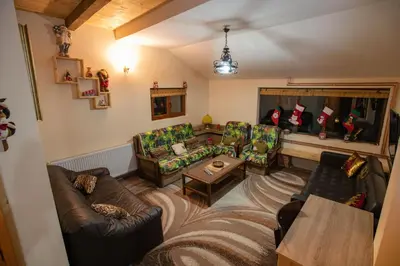 a living room with two couches and a table at Apartmani SP Jovanovic in Crni Vrh