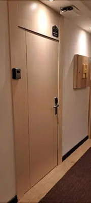 a door in a room with a sign on the wall at GALA Kop Apartman in Kopaonik