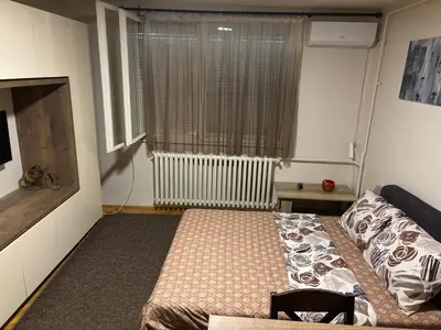 a small room with a bed and a window at Sofi Apartment Nis in Niš