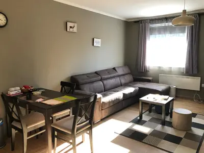 a living room with a couch and a table at Apartman 217 in Kopaonik