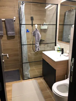 a bathroom with a shower with a toilet and a sink at Apartman 217 in Kopaonik