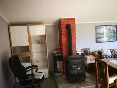 a living room with a wood stove and a table at 
