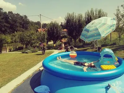 a person laying in a swimming pool in a inflatable at 