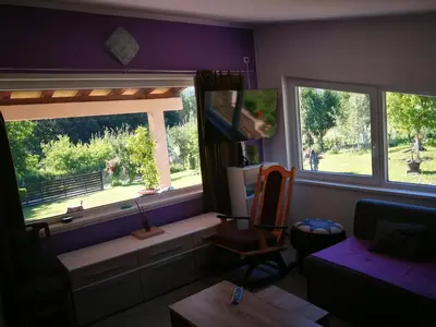 a living room with a couch and two windows at 