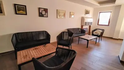 a living room with chairs and a table at Studio apartman p13 in Kopaonik