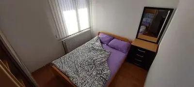 a small bedroom with a bed and a dresser at Apartman Ivanovic 4 in Soko Banja