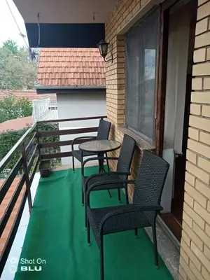 a patio with two chairs and a table on a balcony at Apartman Ivanovic 4 in Soko Banja